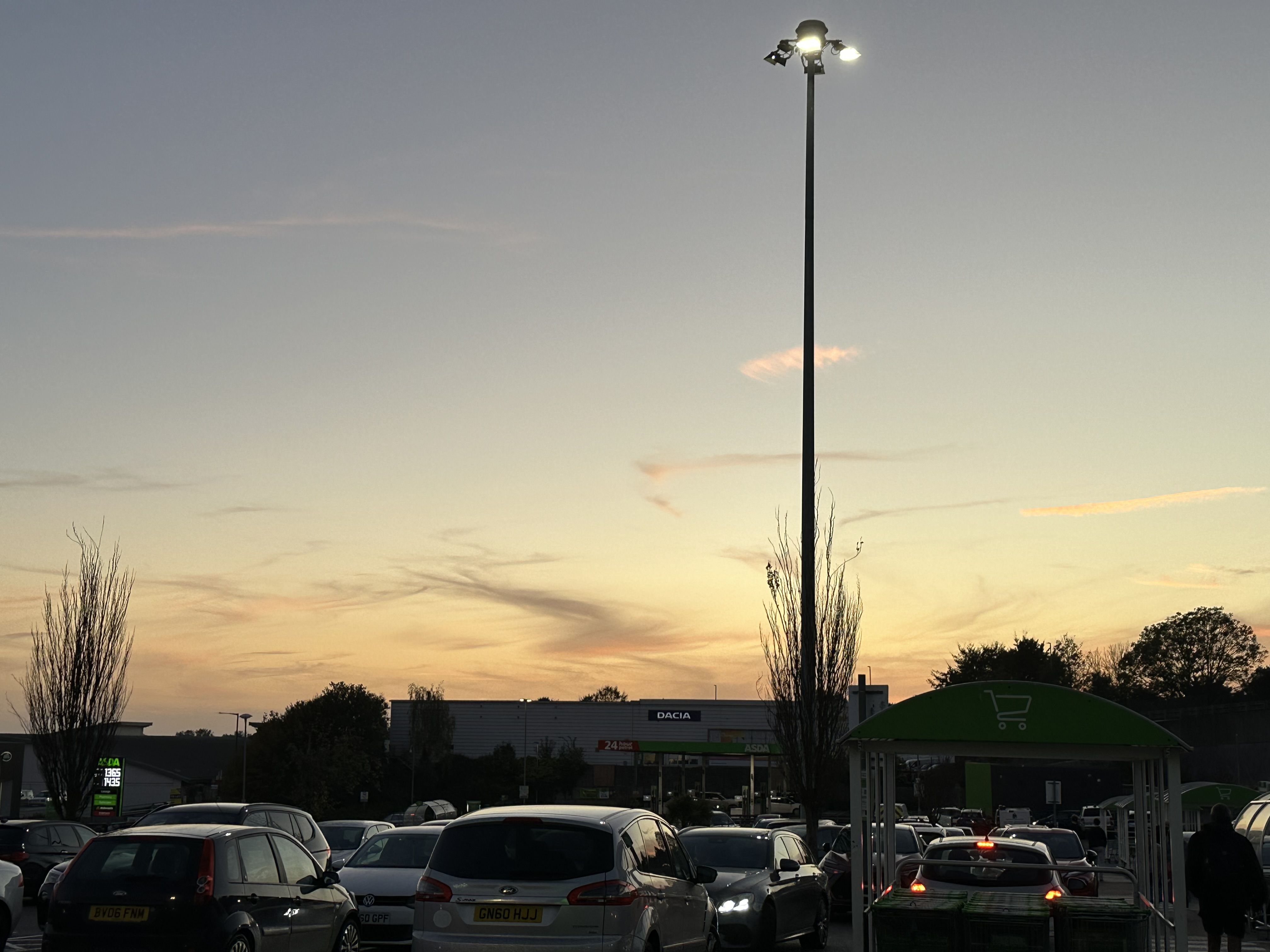 Photo of the sunset sky over a car park