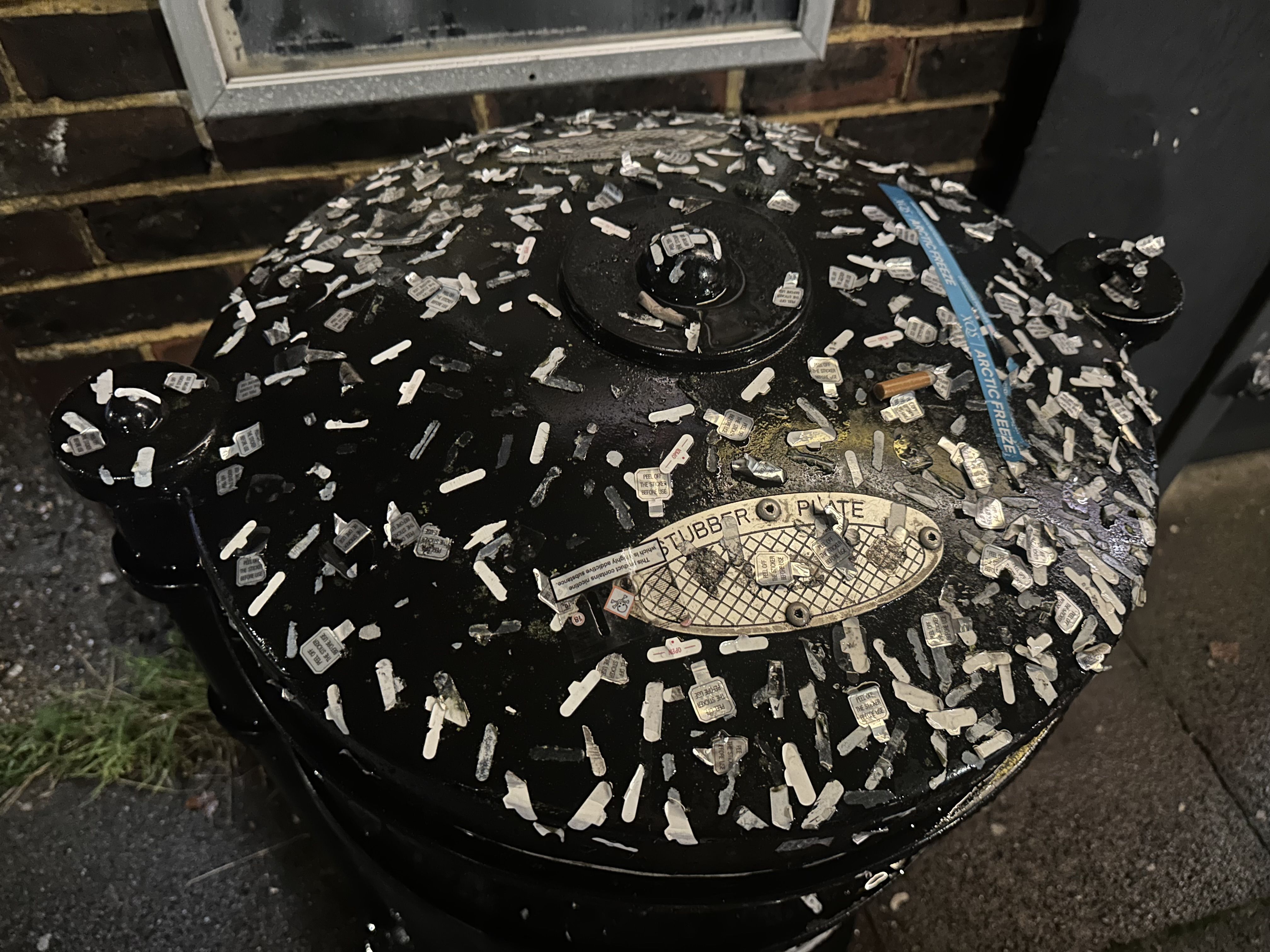 Photo of a bin covered in stickers