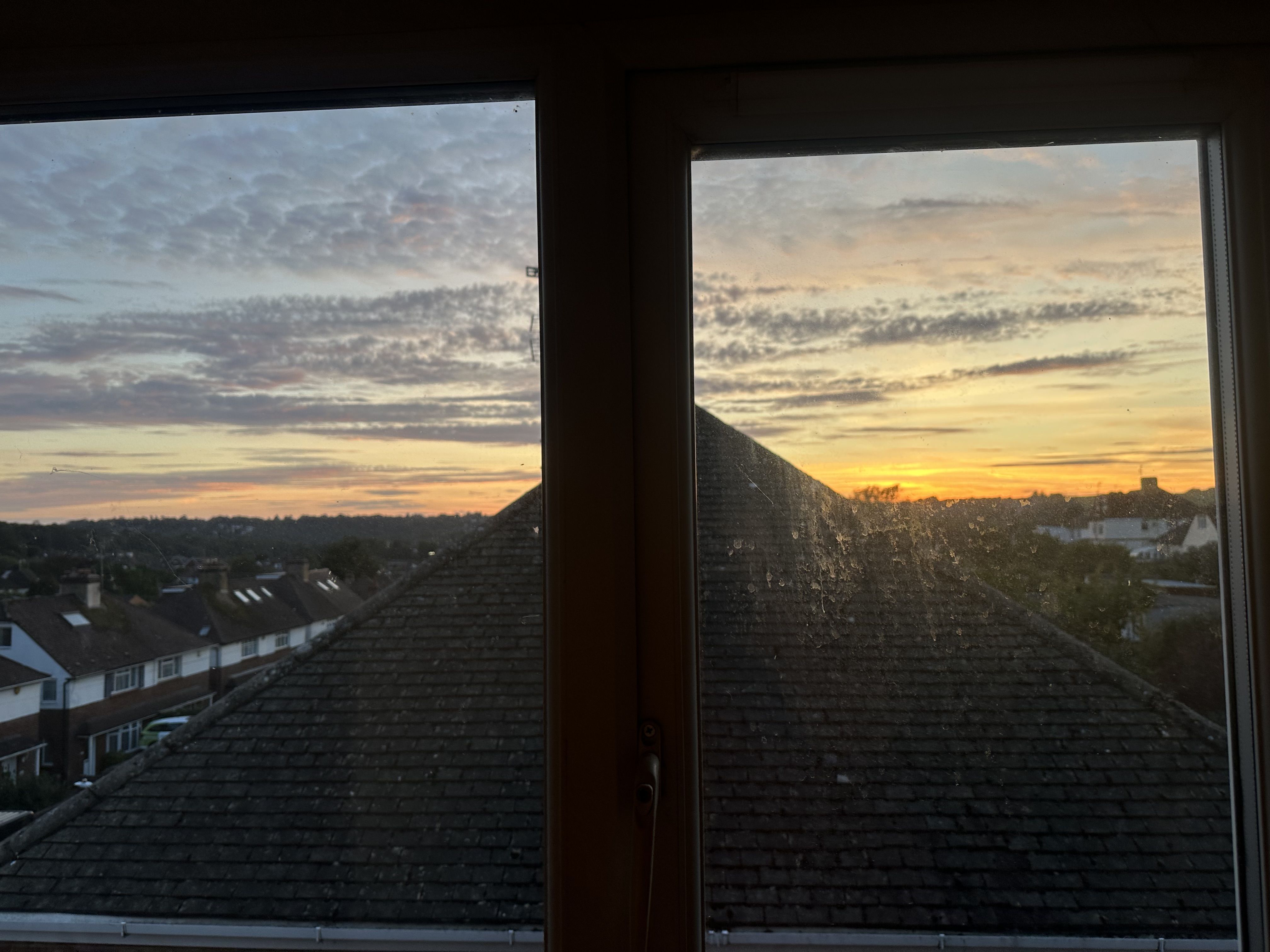 Photo of a sunset out of a dirty window