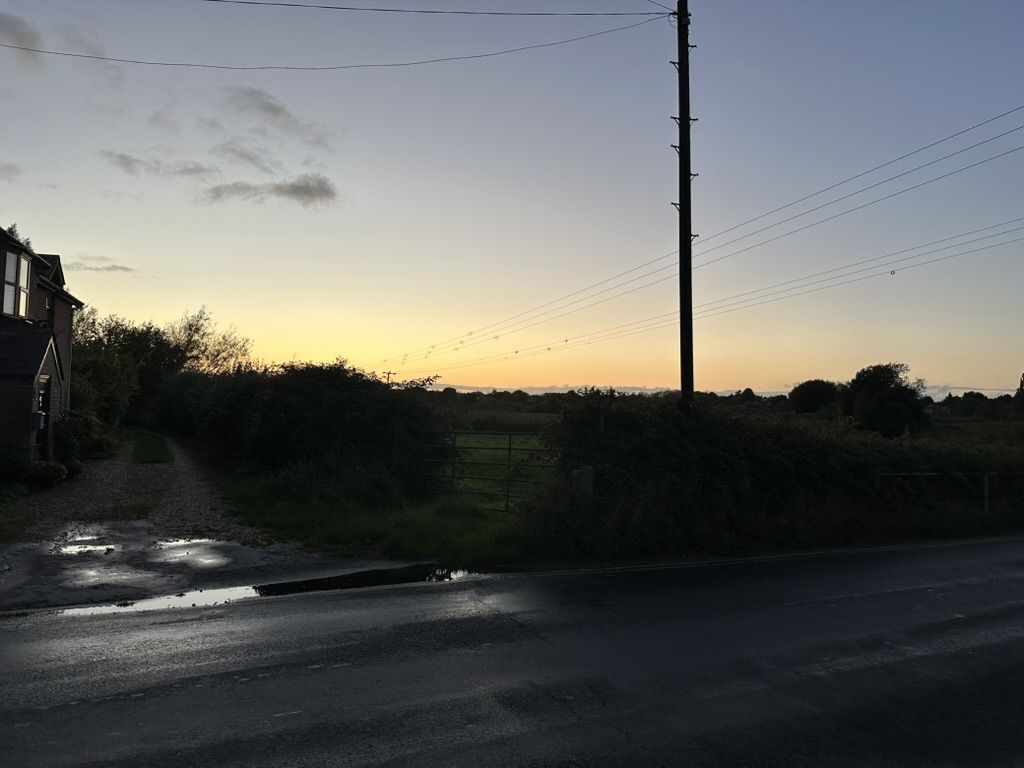 Photo of a sunset above a floodplain